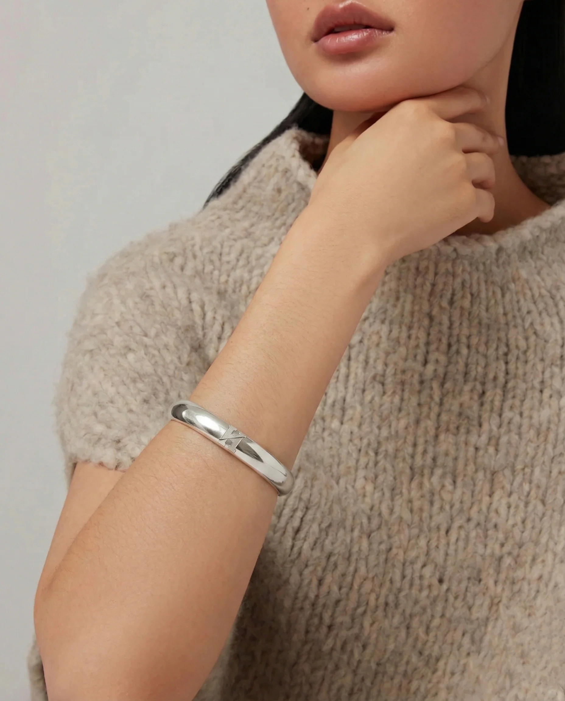 H cuff bracelet worn on the wrist