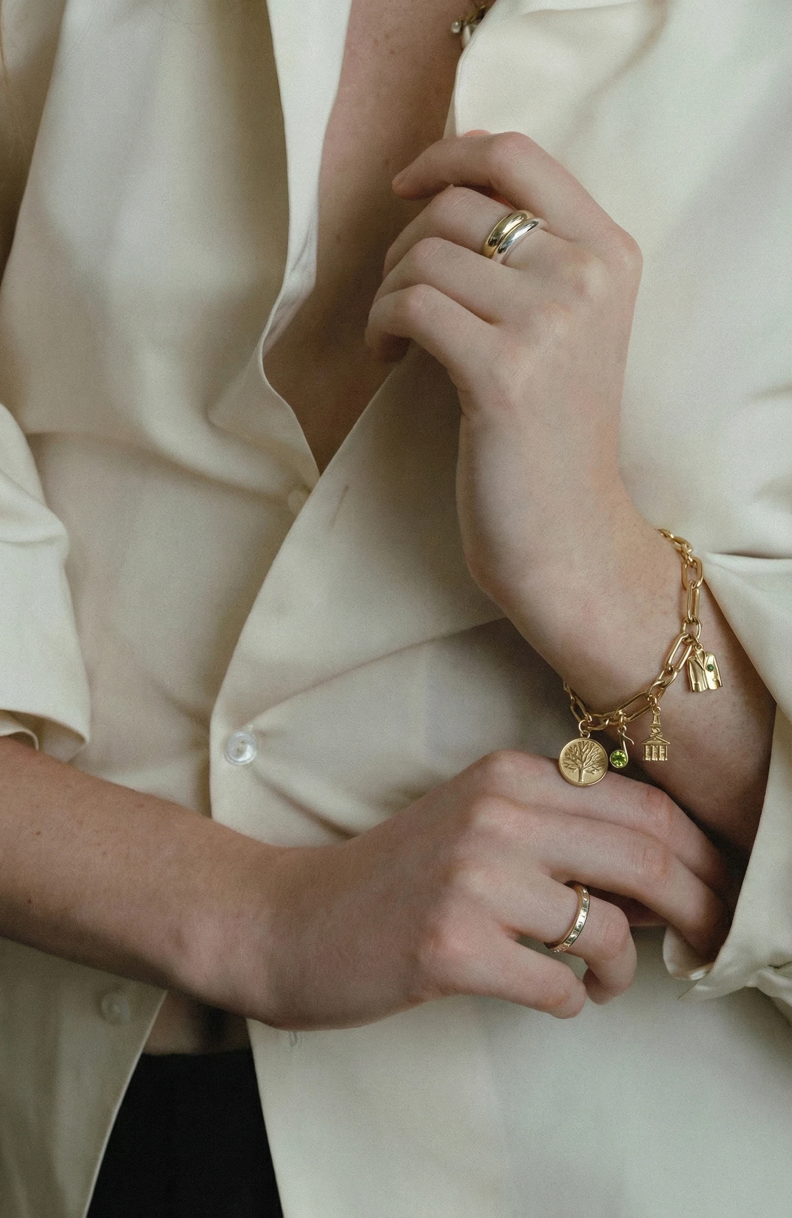 A Loom charm bracelet worn in a quiet, natural moment