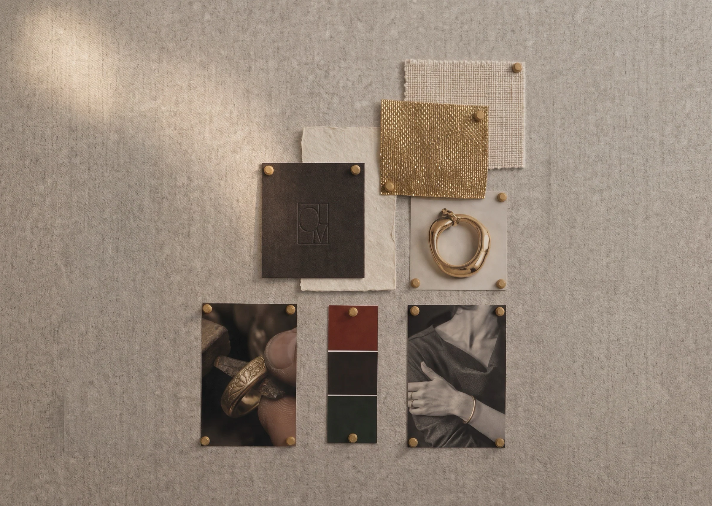 Loom materials board with gold jewelry, textiles, and archival photographs