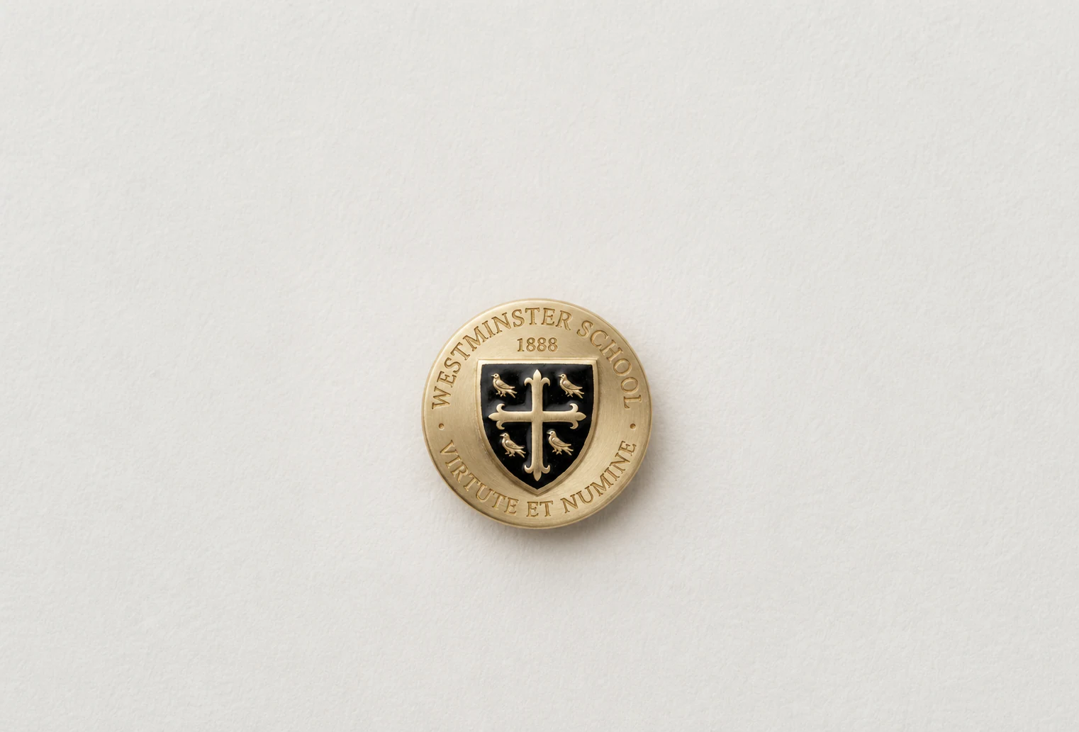 Westminster crest lapel pin on ivory paper